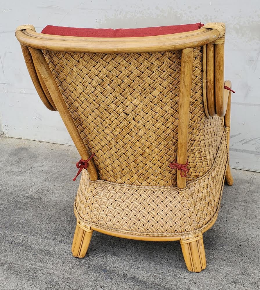 Wicker armchair with red cushion