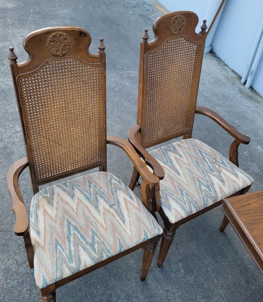Dark wood dining table with 6 wicker/cane/ rattan high back chairs and 3 leaves
