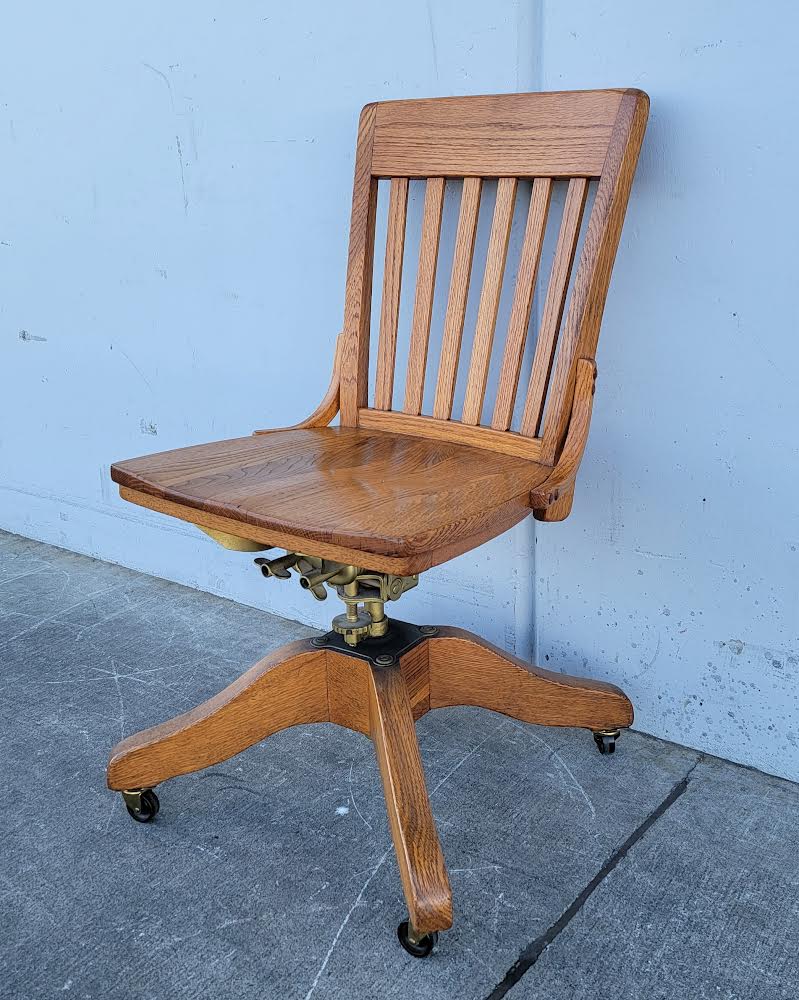 Antique/ vintage oak swivel office/bankers rolling chair on wheels