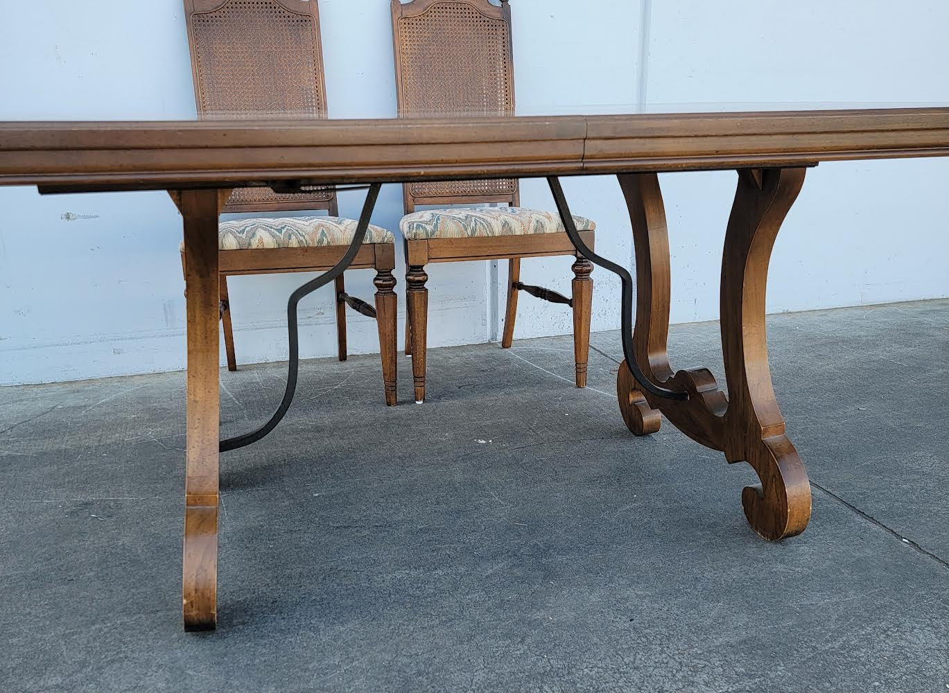Dark wood dining table with 6 wicker/cane/ rattan high back chairs and 3 leaves
