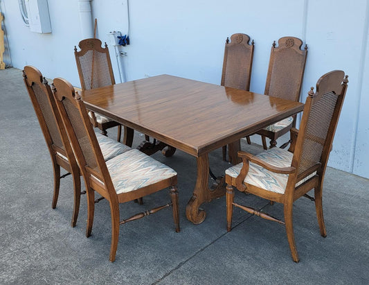 Dark wood dining table with 6 wicker/cane/ rattan high back chairs and 3 leaves