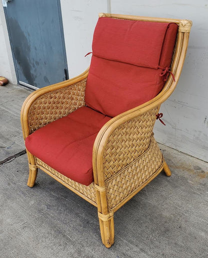 Wicker armchair with red cushion