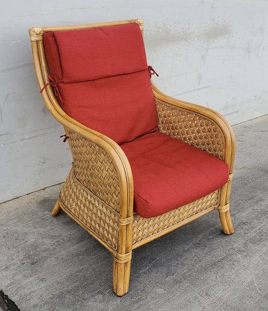 Wicker armchair with red cushion