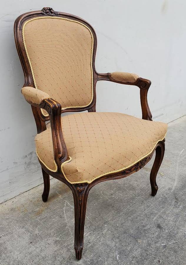 Gilberd’s tan/dark wood armchair