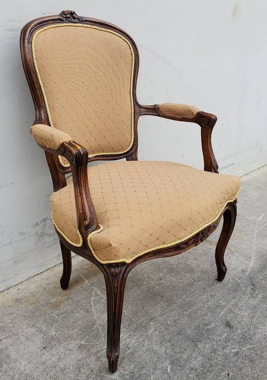 Gilberd’s tan/dark wood armchair