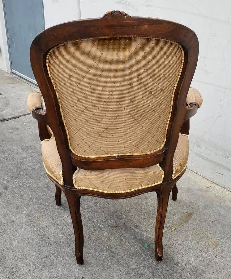 Gilberd’s tan/dark wood armchair