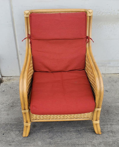Wicker armchair with red cushion