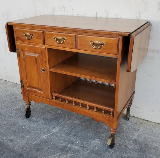 Dark wood kitchen buffet cabinet on wheels with drop side leaves