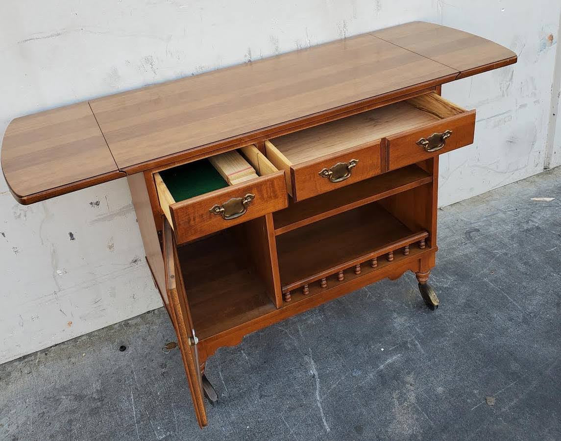 Dark wood kitchen buffet cabinet on wheels with drop side leaves