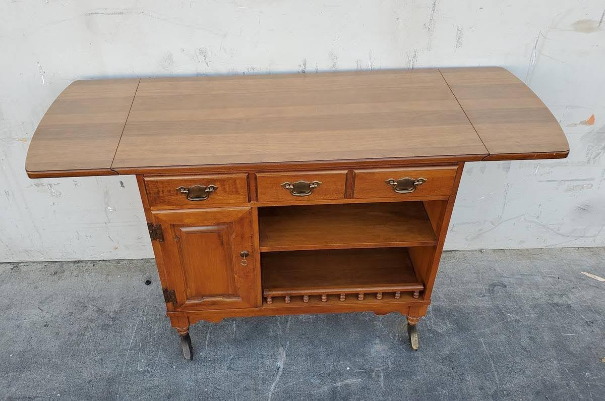 Dark wood kitchen buffet cabinet on wheels with drop side leaves