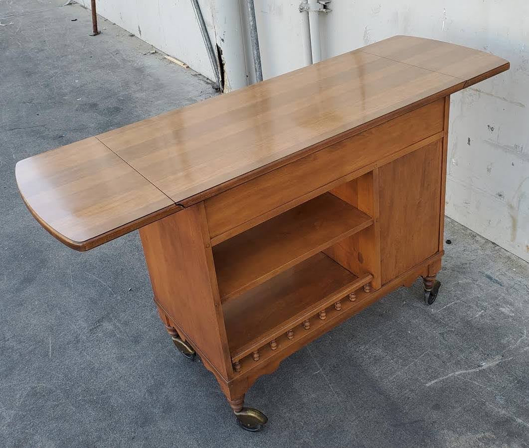 Dark wood kitchen buffet cabinet on wheels with drop side leaves